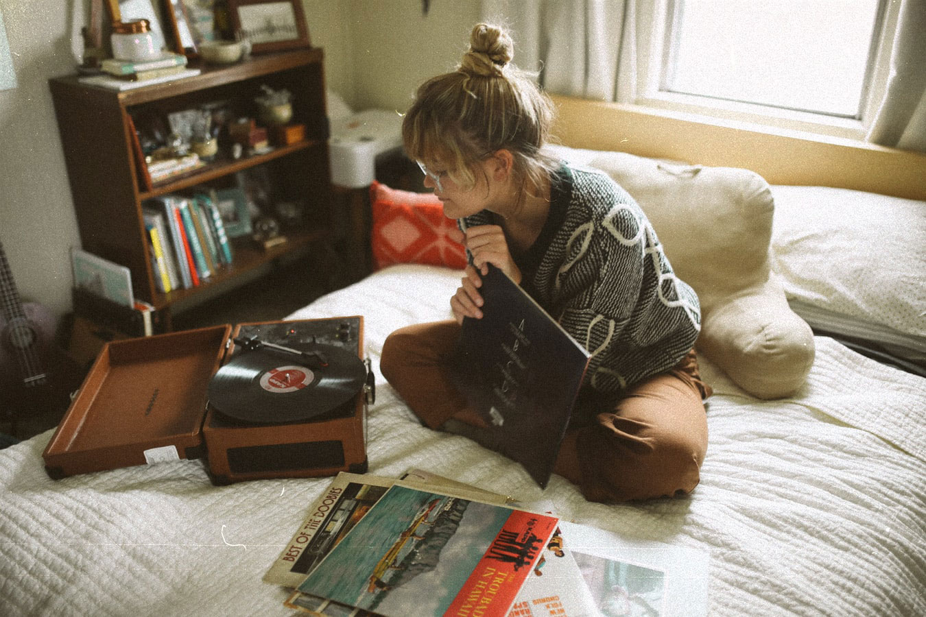 photo of a girl in her room listening to a record player | by aerosphotos @ unsplash.com